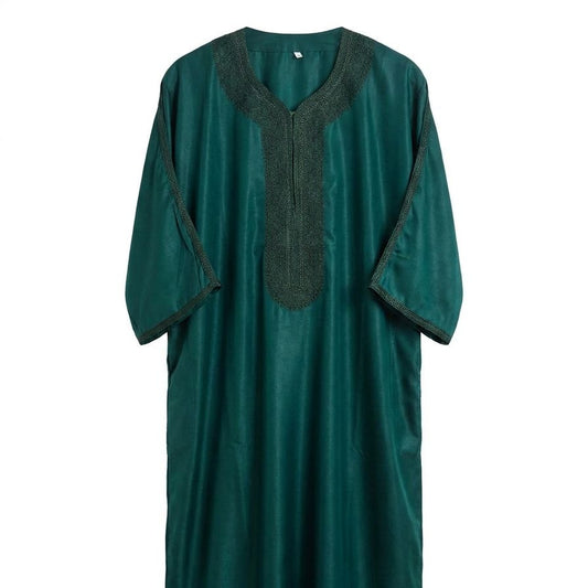 Green dress with black neckline on a white background